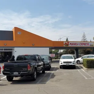 a group of people standing in a parking lot