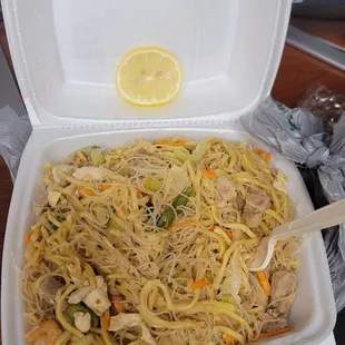 a takeout container of noodles