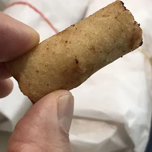 a hand holding a piece of bread