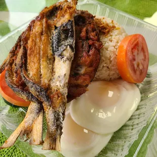 Bangsilog (Marinated milkfish, garlic fried rice, 2 fried eggs) side of tomato and cucumber.