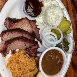 a plate of meat and sides