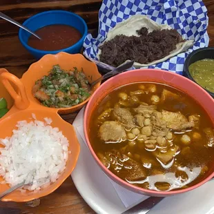 a bowl of soup and bowls of rice