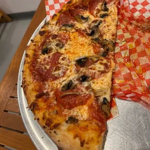 two slices of pizza on a tray