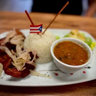 Fried pork chunks, topped with pickled onions and white rice with delicious beans