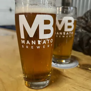 two glasses of beer on a table