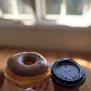 Chocolate donut and regular coffee