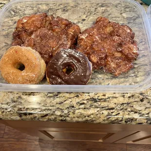 Enormous scrumptious apple fritters and delicious glazed & chocolate glazed donuts.