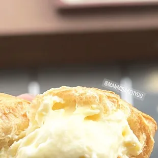 a hand holding a pastry