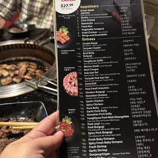 a hand holding a menu