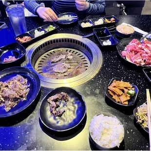 We ordered several meats, fried rice, steamed rice, fish cakes, bean sprouts, kimchi, pickled salad, tempura vegetables, and fried chicken.