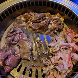 meat being cooked on a grill