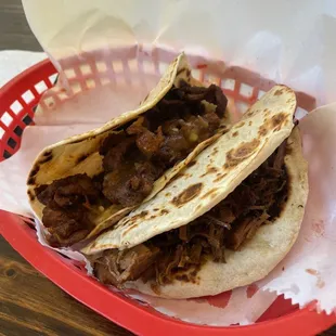 two tacos in a basket on a table