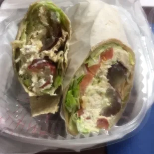 a sandwich wrapped in a plastic container