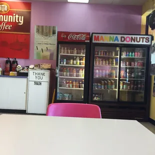 a white table with pink chairs
