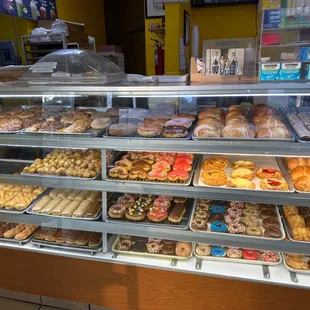 a variety of donuts in a display case
