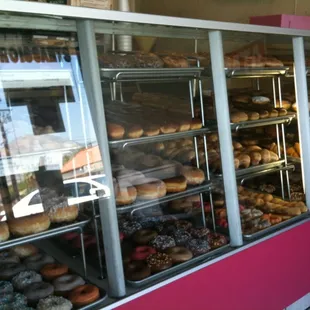 a variety of donuts in a display case