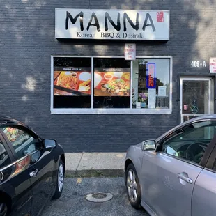 two cars parked in front of a restaurant