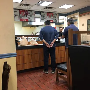 two men standing at the counter