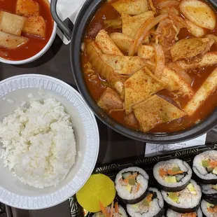 a tray of sushi and a bowl of rice