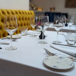 a table set with empty wine glasses