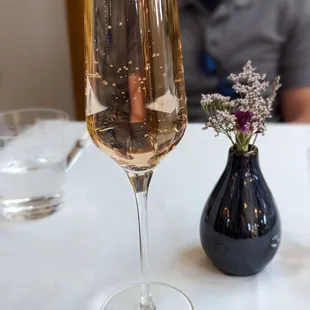 a man sitting at a table with a glass of wine