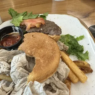 Cold  1/2 eaten cheese burger.