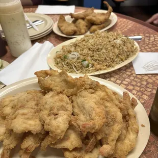 two plates of fried chicken and rice