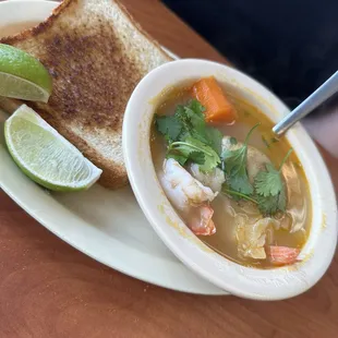 a bowl of soup and a grilled cheese sandwich