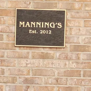 a sign on a brick wall