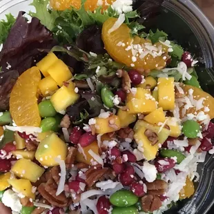 Tropical salad. Includes: mangoes, mandarin oranges, pomegranate seeds, shredded coconut, lima beans, mixed greens. Goat cheese?