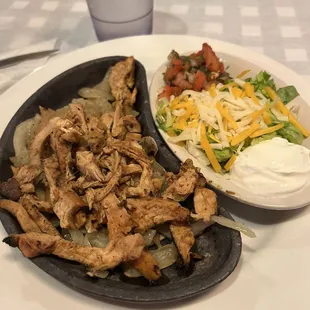 Chicken fajitas with all the condiments on the side