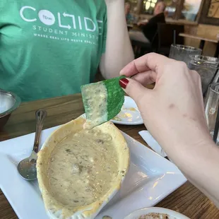 a person eating a bowl of soup