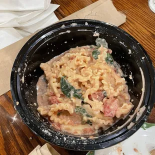 Cheese wheel pasta with tomatoes and spinach