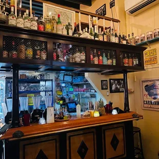 a bar with a lot of liquor on the shelves