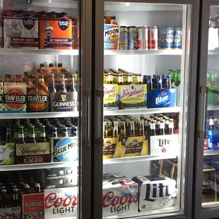 Fully stocked beer cooler with seasonal beers like Sam Adams Oktoberfest, Blue Moon Harvest, Southern Tier Pumpkin, and Travelers Jacko!