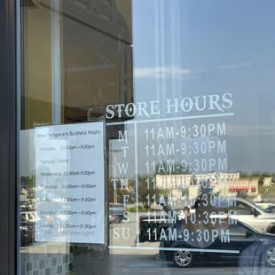 a store hours sign in the window