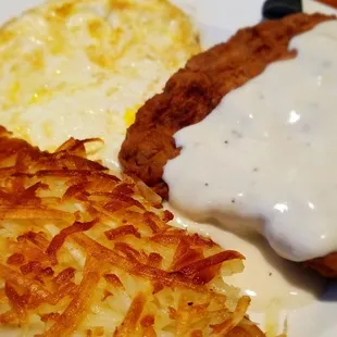 Chicken fried steak with hashbrowns and over hard eggs.  Tasty!
