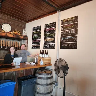 a man and a woman sitting at a bar