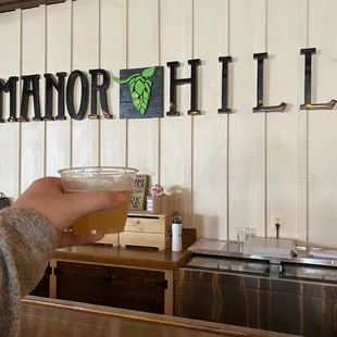 a person holding a glass of beer