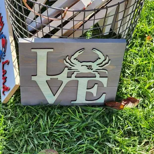 a crate of beer and a sign that says love crab
