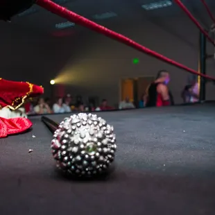 a ring with a ball of beads on the floor