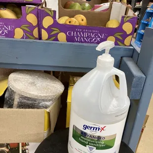 a bottle of vinegar on a stool in a grocery store