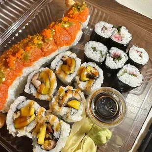 a tray of sushi and rolls