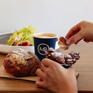 Almond croissant, salmon toast, and latte