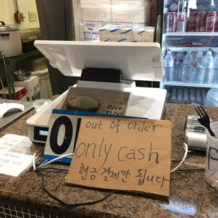 a sign on a cash register