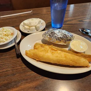 Two piece Perch dinner with baked potato and cole slaw.