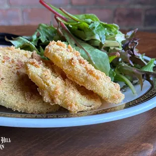 Fried Green Tomatoes with fresh greens and signature sauce