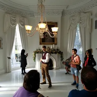 a group of people standing in a dining room
