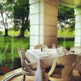 If you can, eat on the veranda. There is a beautiful view of the grounds but a pane of glass between you, the heat and the bugs!