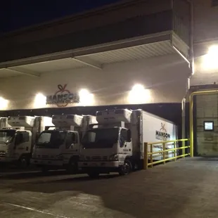 trucks parked in front of a gas station